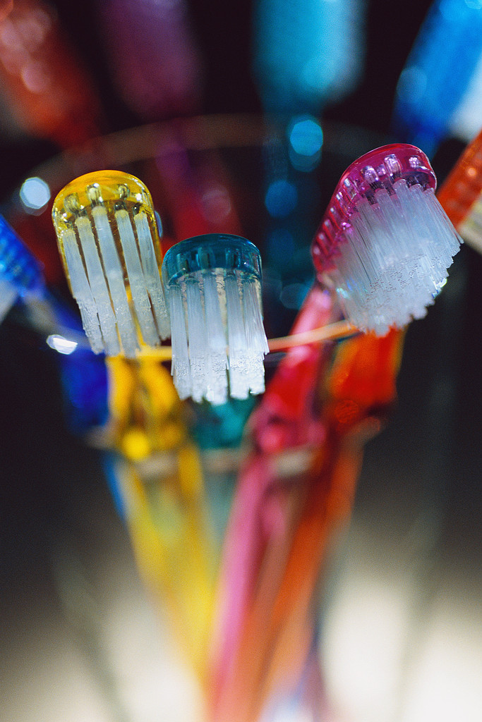 Disinfect an old toothbrush with antibacterial soap and